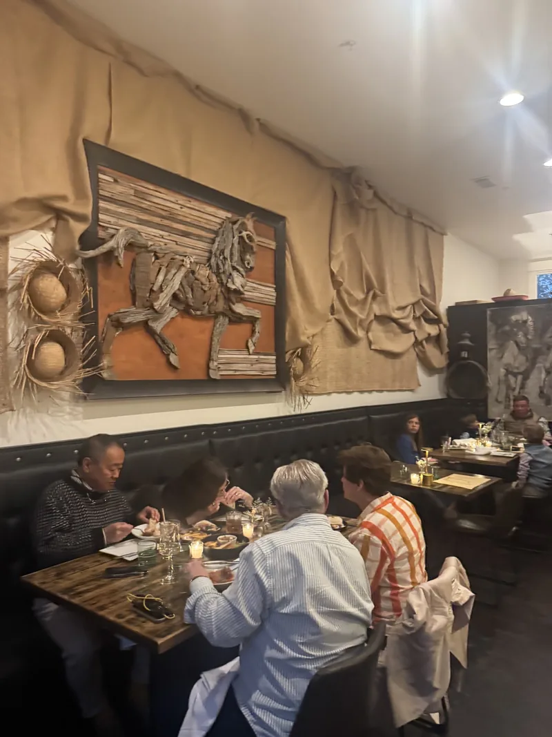 Guests dining beneath the horse relief in the dining room